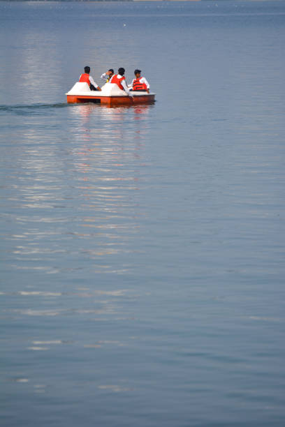 Unidentified people riding boat during summer vacation BHOPAL, MADHYA PRADESH, INDIA - NOVEMBER 20, 2019: Unidentified people riding boat during summer vacation in bhopal, Madhya Pradesh, India. Travel concept. Happy vacation. bhopal lake stock pictures, royalty-free photos & images