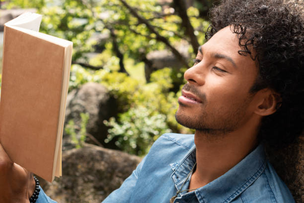 istock man reading book and enjoying nature 1345591109