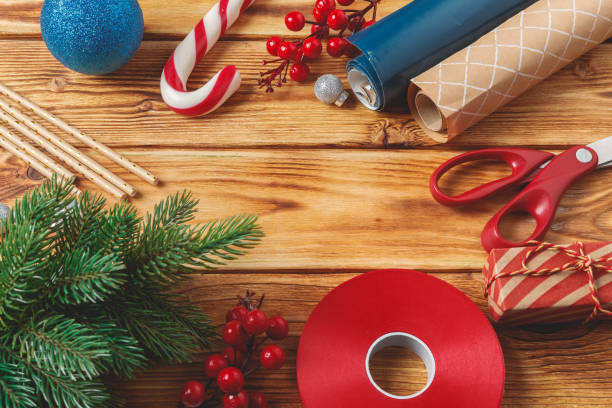 istock Christmas wrapping and decorating items on wooden background with copy space 1345592646