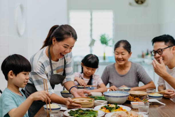 istock Multi generation asian chinese family having lunch together at home 1345599430