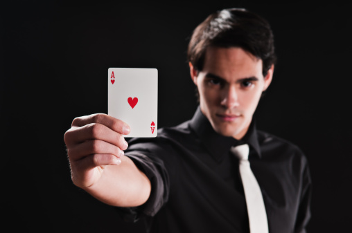 Young adult showing ace of hearts