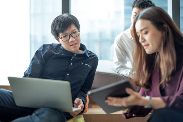 istock Asian colleagues sharing ideas in office meeting room 1345601740