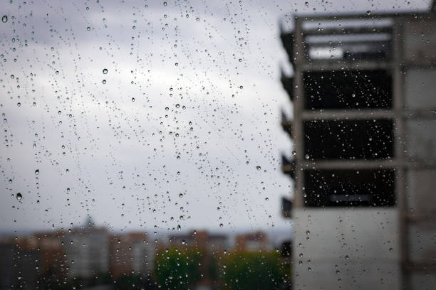 istock A raindrops on glass on the city background 1345603598