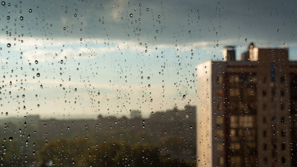 istock A raindrops on glass on the city background 1345603601