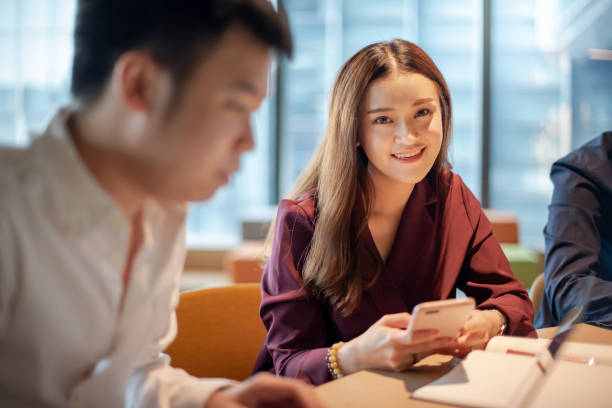 istock Asian colleagues discussing in meeting room 1345603780
