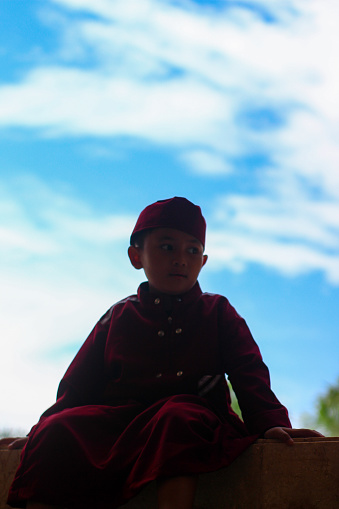 silhouette Muslim boy with the background sky