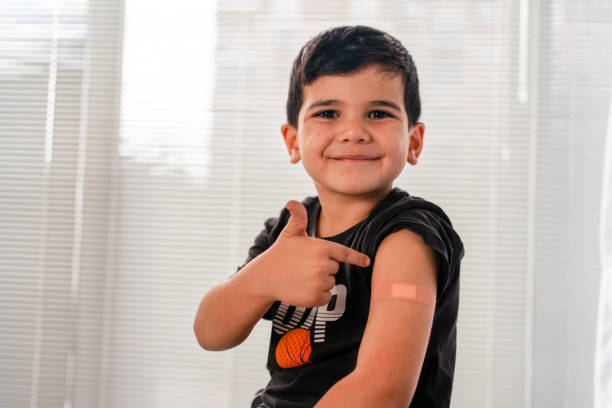 istock Vaccinated child Showing Shoulder After Shot 1345604444