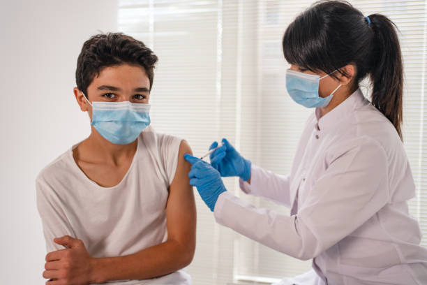 istock teenage boy getting vaccinated 1345604576