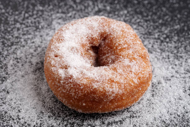 istock Sugar Doughnuts on Dark and Moody Background 1345610788