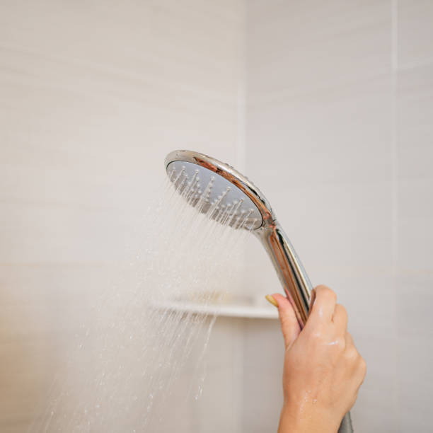 istock a shower can in a woman's hand. plumbing for the bathroom. 1345610918