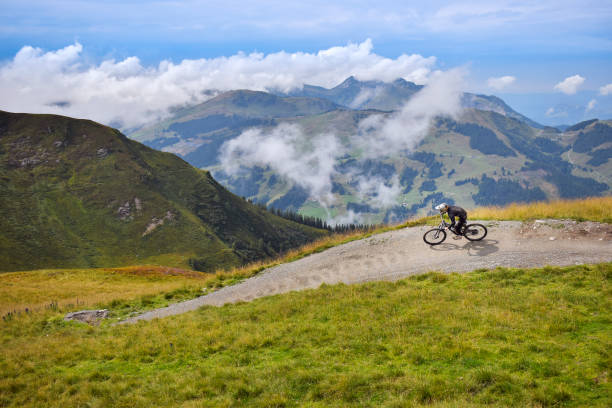 Mountain biker in mountains landscape stock photo