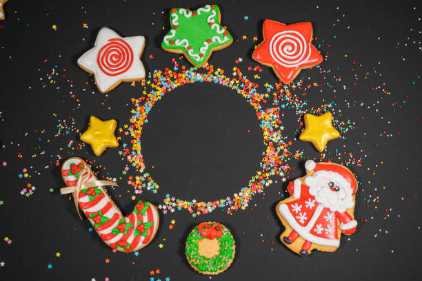 istock Christmas background with gingerbread on gray surface. Holiday mood card. Top view, copy space. Family traditions, DIY, celebration concept. Festive background with homemade gingerbread cookies. 1345613175