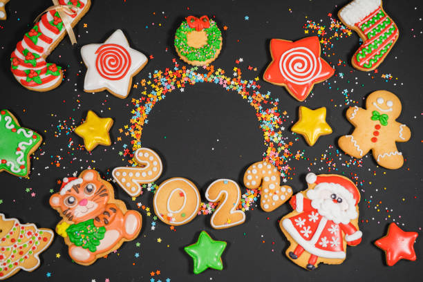 istock Christmas background with gingerbread on gray surface. Holiday mood card. Top view, copy space. Family traditions, DIY, celebration concept. Festive background with homemade gingerbread cookies. 1345613699