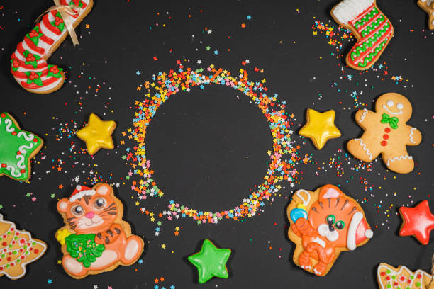 istock Christmas background with gingerbread on gray surface. Holiday mood card. Top view, copy space. Family traditions, DIY, celebration concept. Festive background with homemade gingerbread cookies. 1345613772