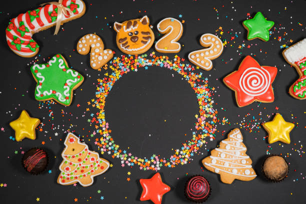 istock Christmas background with gingerbread on gray surface. Holiday mood card. Top view, copy space. Family traditions, DIY, celebration concept. Festive background with homemade gingerbread cookies. 1345613825