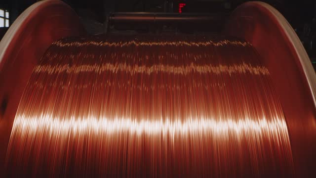 Spinning coil with copper cable in cable plant, close-up