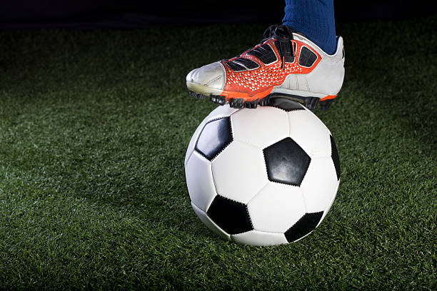 istock Soccer ball resting on a grass field at night 134562325