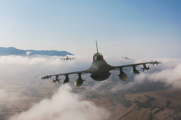 istock Jet fighters flying over the clouds. 1345627272