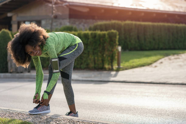 istock Woman tying shoe laces 1345628518