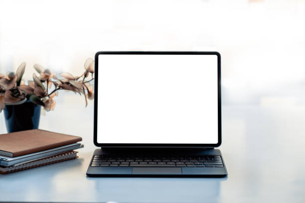 istock Digital tablet with blank screen on white table in office. Mock up. 1345630006