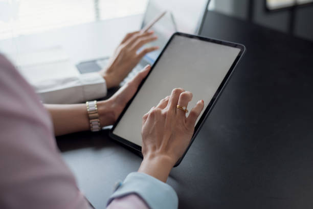 istock Close up. two businesswoman using digital tablet at meeting. 1345630018
