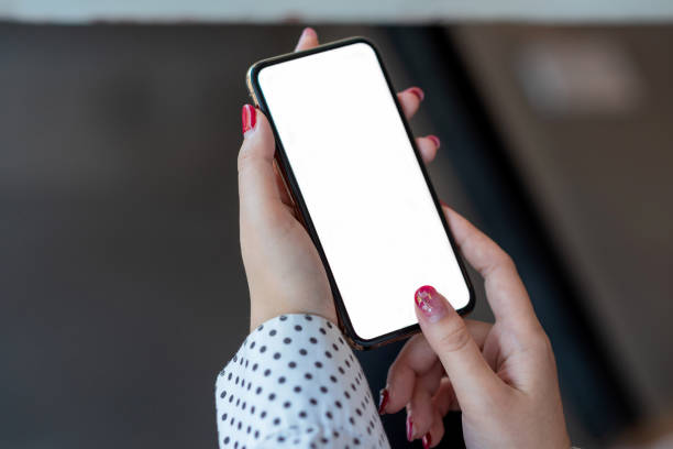 istock Mock up. image of woman holding mobile phone with blank white screen. 1345630044