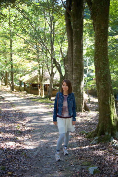 istock Young Woman Walking in Park. 1345630196