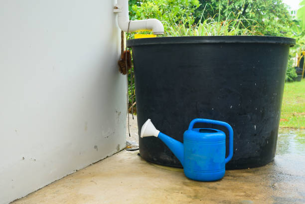 istock Big plastic tank and watering can 1345630230
