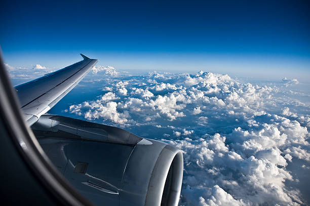 istock Window view of a planes wing above a billowy clouded sky 134563109