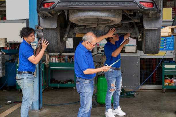 istock Technical team of car garage check about wheel and suspension cu 1345632245