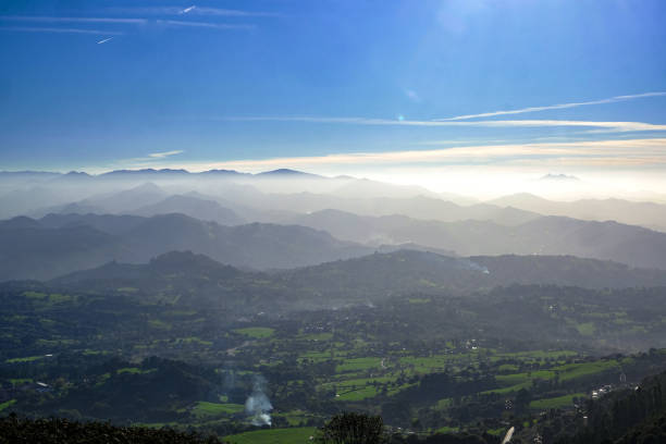 Green fields with fog swept mountains in Asturias, Spain
