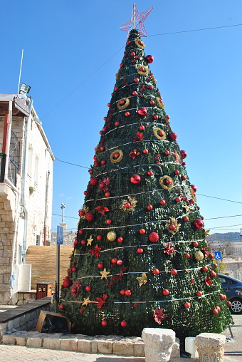 Mi'ilya village. Israel. Arab Christian village in the north of Israel. Church of St Mary Magdalen. Church courtyard and traditional Christmas tree during the holidays.