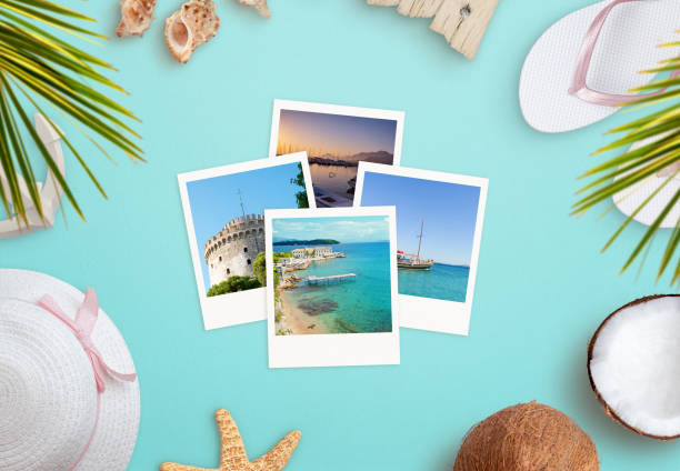 istock Travel photos surrounded by beach accessories concept. Top view, flat lay composition 1345638943