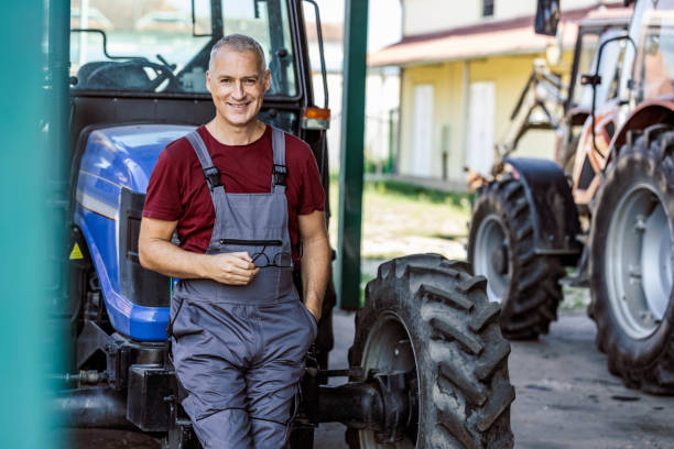farmer man in front of tractors - photography gray hair farmer professional occupation imagens e fotografias de stock