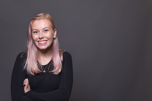 Portrait of a pretty twenty-something female with pink hair