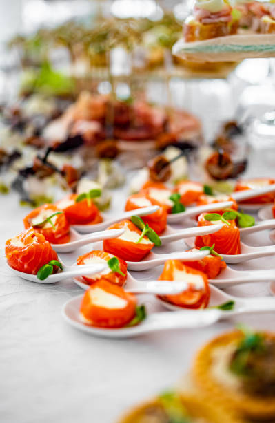 istock salmon appetizers served with white spoons,including smoke salmon rolls and cheese. buffet or catering. 1345641517