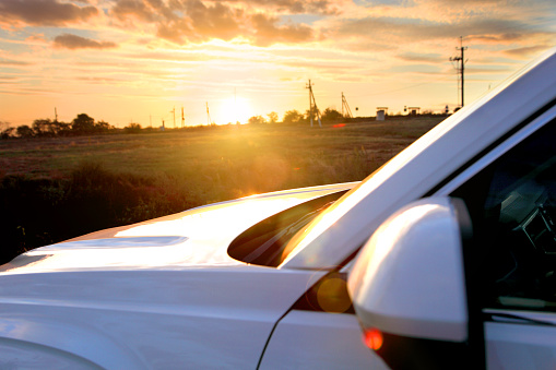 White  car on background of sunset.