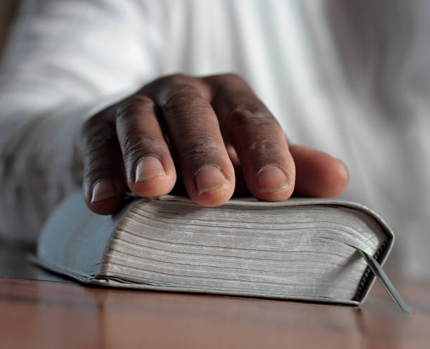 istock man praying with hand stock photo 1345642632