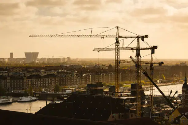 Large construction site in the center of Copenhagen in the evening with the Bella Center and Hotel in the background.