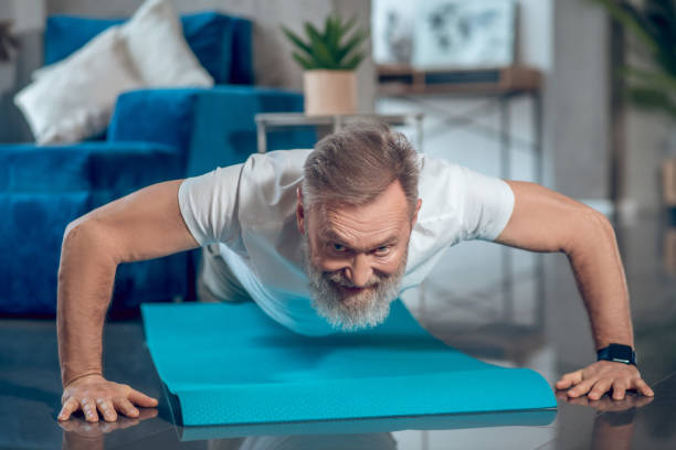istock A mature man having a worout and doing push ups 1345648885