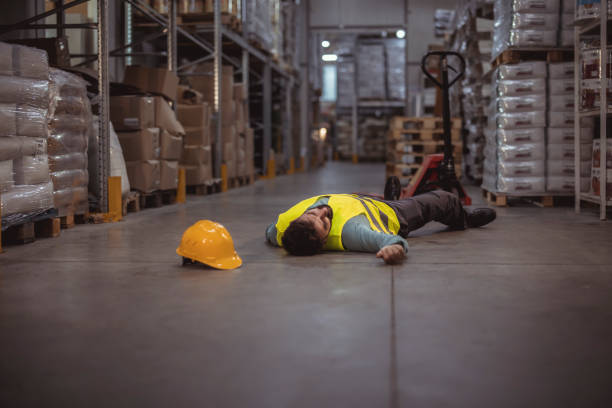 istock Warehouse worker lying unconscious on the concrete floor 1345651161
