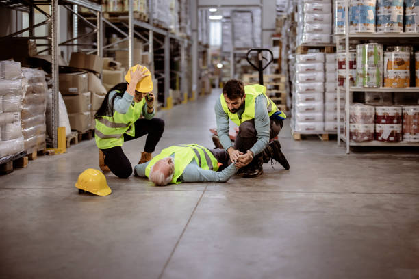 istock Warehouse Workers After an Accident in a Warehouse 1345651248