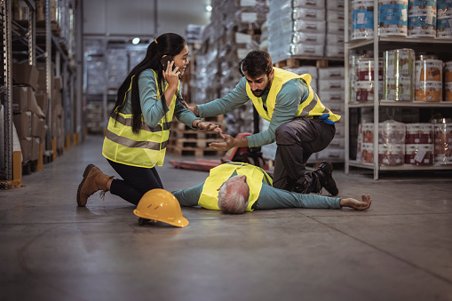 An injured senior worker after an accident in a warehouse