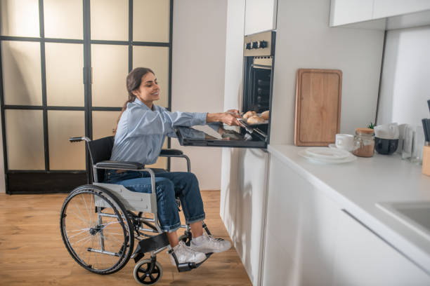 istock A young girl on a wheelchair doing some housework and looking involved 1345652596
