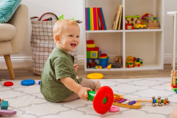 istock Cute Baby Playing With Toy At Home 1345653081
