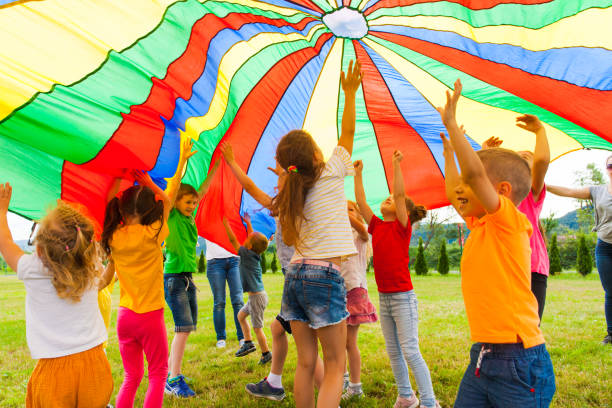 istock Rear View Of People Standing Against Multi Colored Umbrella 1345653084