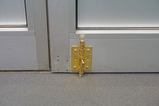 Latch bolt lock at bottom of aluminum doors