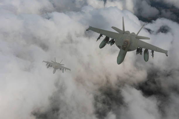 istock Jet fighters flying over the clouds. 1345658797