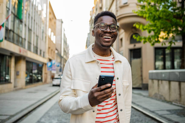 istock Young African-American man uses a mobile phone on the go 1345659005