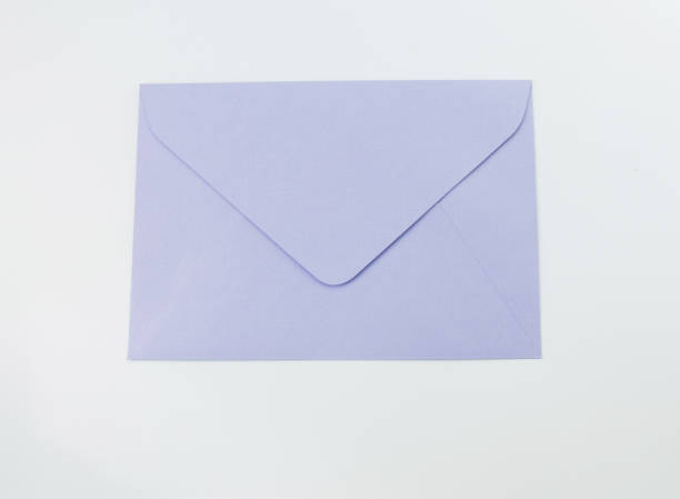 istock gift delicate envelope of purple color with a white bow. 1345662188